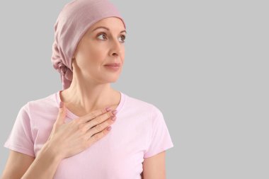 Gri arka planda kemoterapiden sonra olgun kadın, yakın plan.