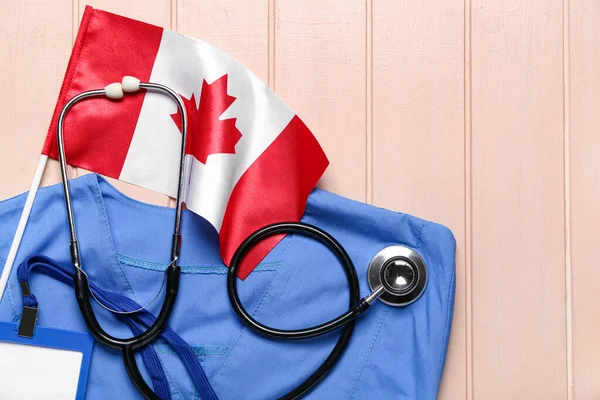 Canadian Flag Doctor Uniform Badge Stethoscope Beige Wooden Background Closeup — Stock Photo, Image