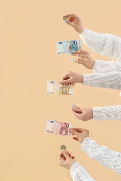 Women with money on beige background