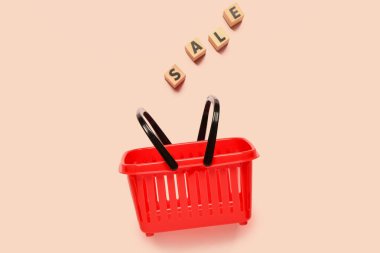 Bej arka planda metin indirimli küçük kırmızı alışveriş sepeti