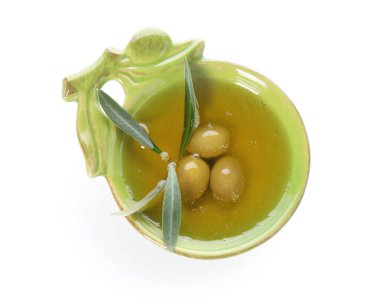 Bowl of fresh olive oil on white background