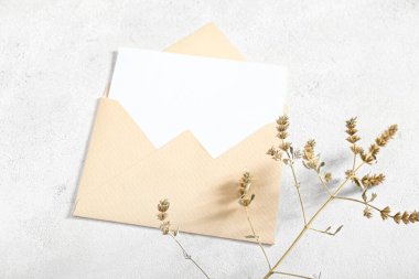 Boş kartla zarf ve beyaz grunge arka planda kurumuş dal