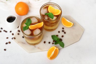 Açık arkaplanda lezzetli portakal espresso bardakları