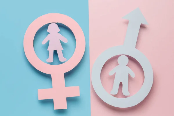 Paper symbols of male and female with couple figures on color background