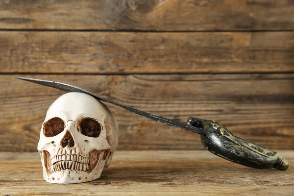 Human Skull Sword Brown Wooden Background — Stock Photo, Image
