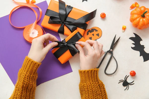 Woman Different Decorations Tying Bows Gift Boxes Halloween White Background — Stock Photo, Image