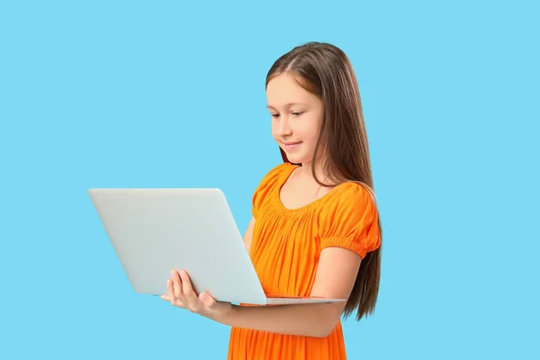 Mavi Arka Planda Dizüstü Bilgisayarı Olan Şirin Küçük Bir Kız — Stok fotoğraf
