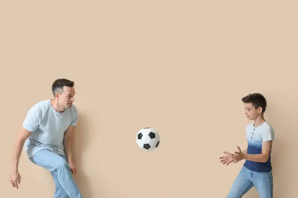 Little Boy His Dad Playing Football Beige Background — Stock Photo, Image