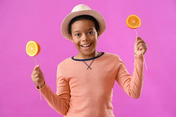 Little African American Boy Slices Orange Sticks Purple Background — Stock Photo, Image
