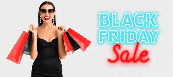 Banner for Black Friday with beautiful young woman and shopping bags