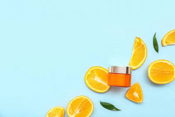 Jar Cream Cut Orange Leaves Blue Background — Stock Photo, Image