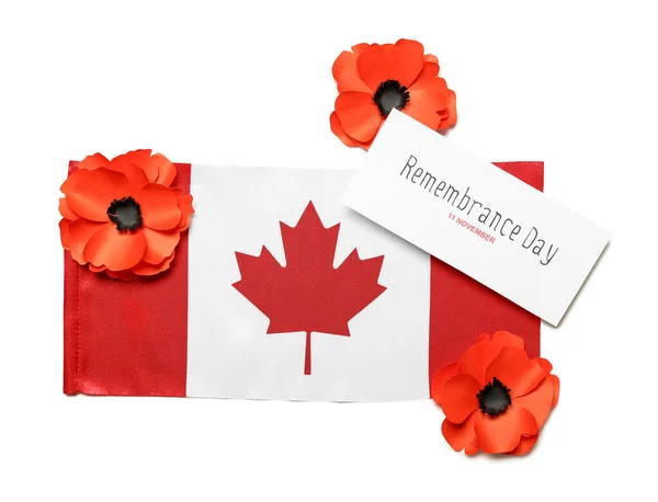 Poppy flowers, flag of Canada and card on white background. Remembrance Day