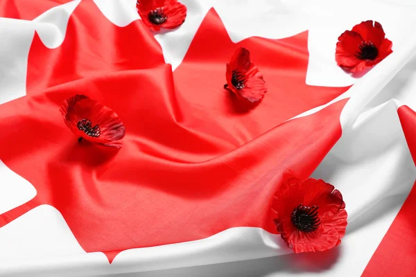 Poppy flowers on flag of Canada as background. Remembrance Day