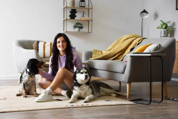 Young woman with cute dogs at home