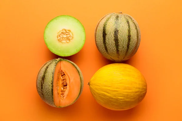 stock image Tasty ripe melons on orange background