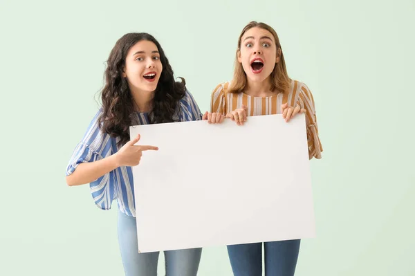 Surprised Young Women Big Blank Poster Mint Background — Stock Photo, Image