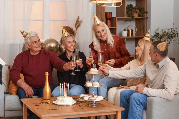 Mature people with champagne celebrating Birthday at home