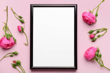 Pembe arka planda çiçekli boş fotoğraf çerçevesi