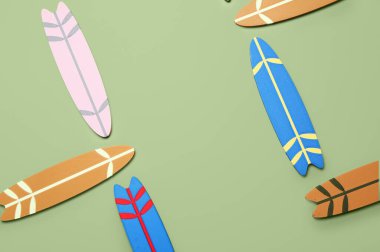 Yeşil arka planda farklı mini sörf tahtaları