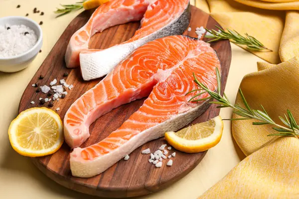 Wooden Board Raw Salmon Steaks Different Spices Yellow Background — Stock Photo, Image