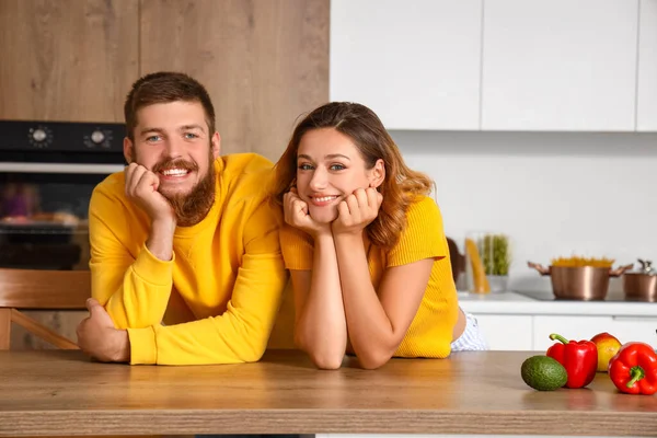 Happy couple in love at table in kitchen