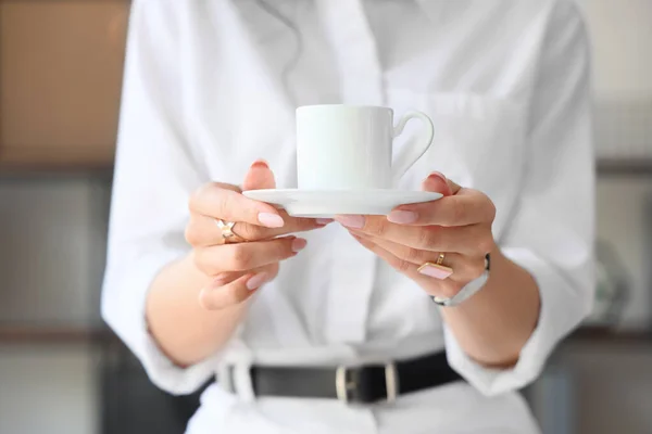 stock image Beautiful businesswoman with cup of coffee in office, closeup