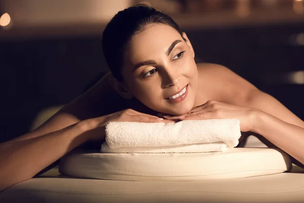 Young woman relaxing in dark spa salon, closeup