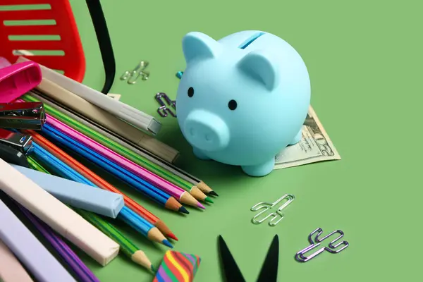 Different School Stationery Piggy Bank Money Green Background — Stock Photo, Image