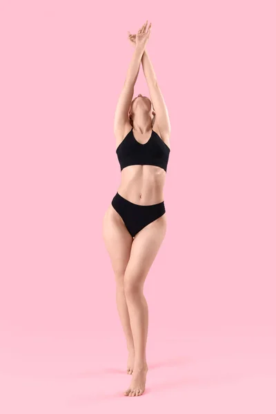 stock image Beautiful woman in underwear on pink background