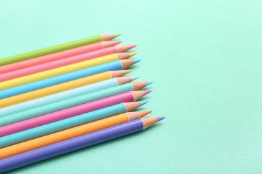 Turkuaz arka planda birçok renkli kalem