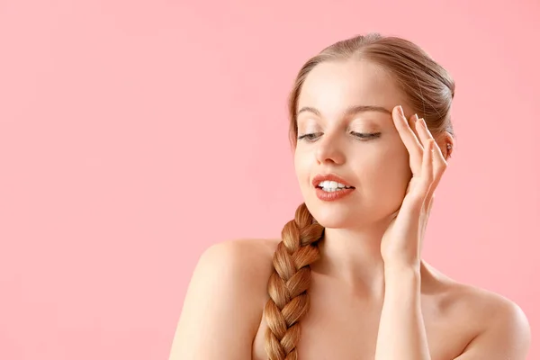 Pretty young woman on pink background. Skin care concept