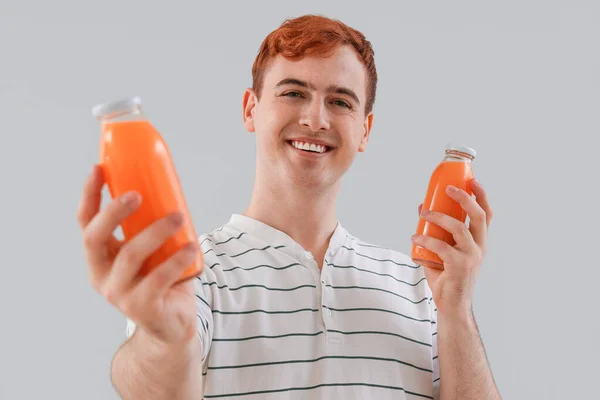 Young Man Bottles Juice Light Background Closeup — Stock Photo, Image