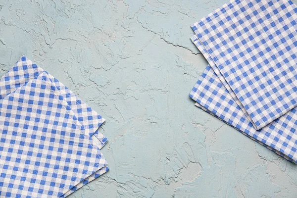 Set of clean folded napkins on color background