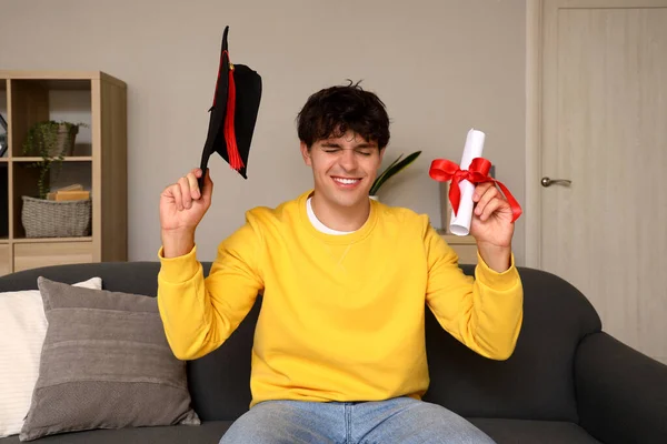 stock image Male graduate student with diploma video chatting at home