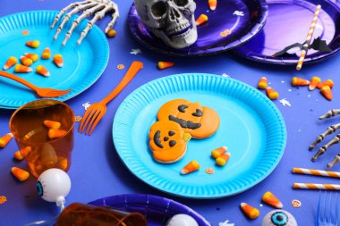 Mavi arka planda Cadılar Bayramı süslemeleri olan şenlik masası.