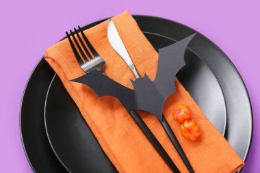 Mor arka planda Cadılar Bayramı sopası ve balkabağı ile şenlik masası