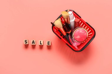 Makyaj malzemeli alışveriş sepeti ve pembe arka planda metin satışı