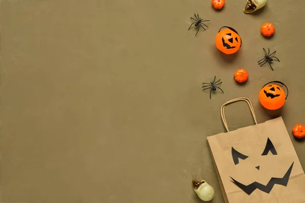 Composition with shopping bag and Halloween decorations on grunge background