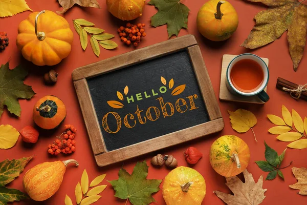 stock image Chalkboard with text HELLO OCTOBER and beautiful autumn decor on brown background