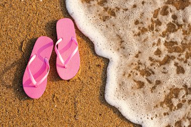 Tatil köyünün okyanus kıyısındaki kumda şık taklalar atıyor.