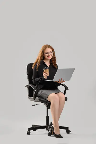 Jovem Empresária Com Laptop Xícara Café Sentado Cadeira Fundo Claro — Fotografia de Stock