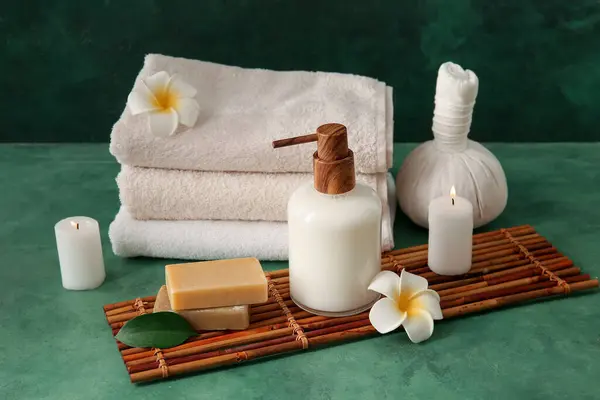 Set of spa supplies on green background