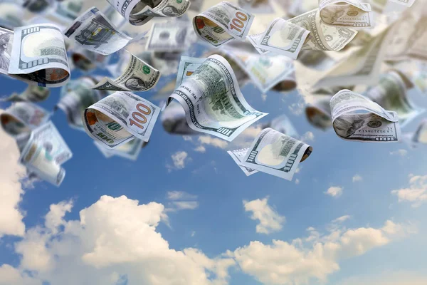 Many dollar banknotes falling from sky