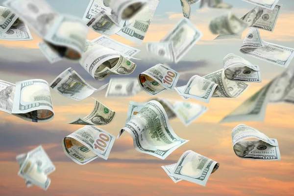 Many dollar banknotes falling from sky