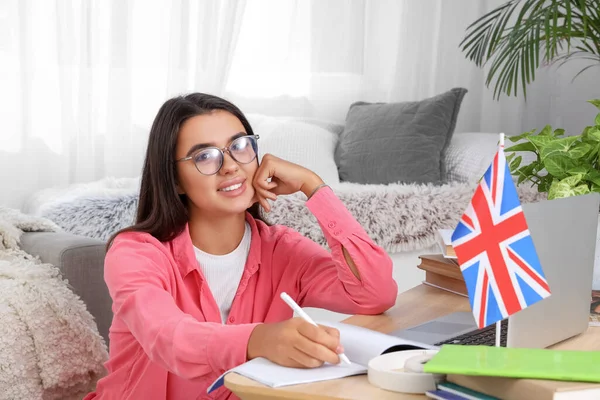 Young woman learning English language online at home