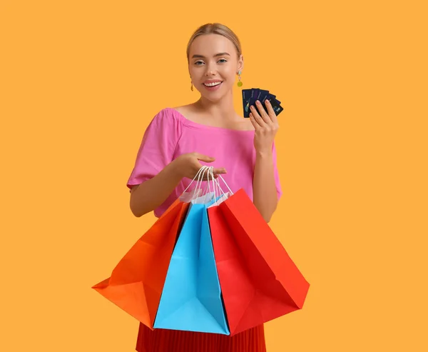 Pretty Young Woman Credit Cards Shopping Bags Orange Background — Stock Photo, Image