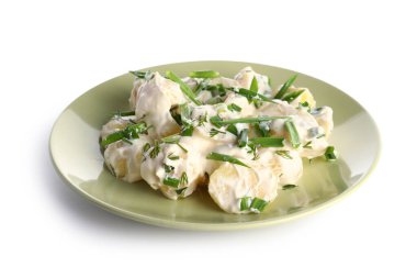 Beyaz arka planda yeşil salatalı lezzetli patates salatası.
