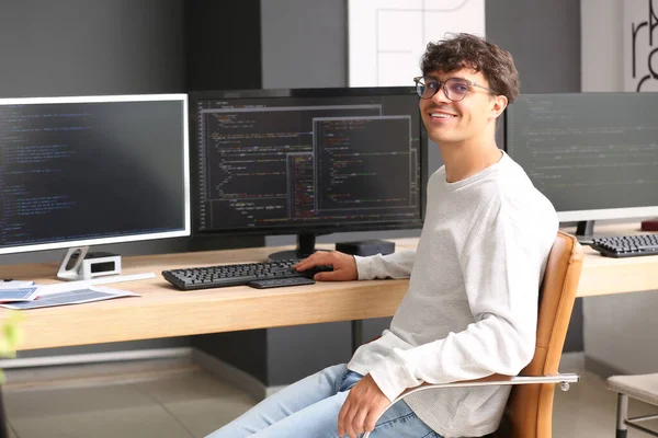 Male programmer working at table in office