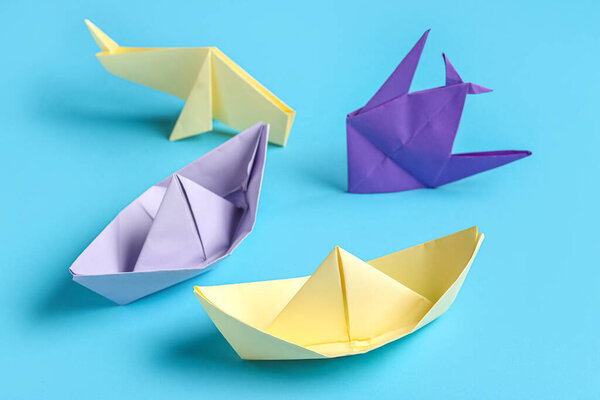 Красочные лодки оригами и животные на фиолетовом фоне