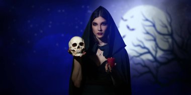 Young witch with skull and candle at night clipart